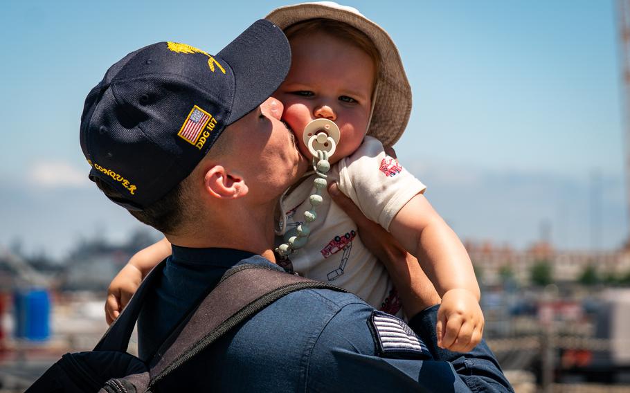 Sailor hugs and kisses his son.